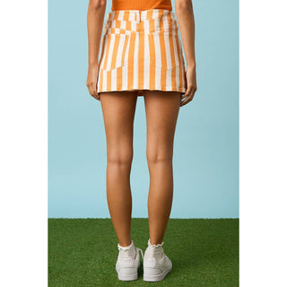 Orange and white striped mini skirt with back patch pockets, worn with white sneakers