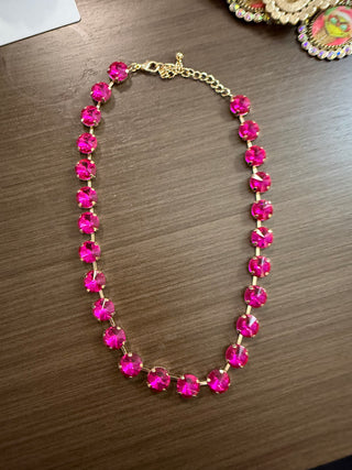 Hot pink faceted rhinestone choker necklace with gold-tone prong settings and extender chain
