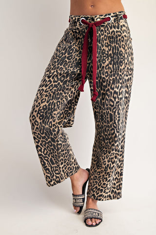 Wide-leg leopard print pants with burgundy braided drawstring and metal grommet waistband