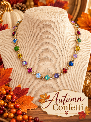 Multicolor crystal statement necklace in gold-tone bezels on beige jewelry bust
