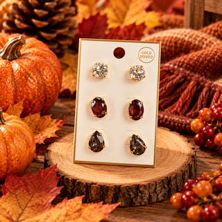 Three-pair gold-dipped stud earring set with clear, red oval, and smoky teardrop stones