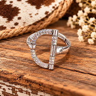 Silver spur-shaped stretch bracelet with iridescent rhinestones and cylindrical spacers