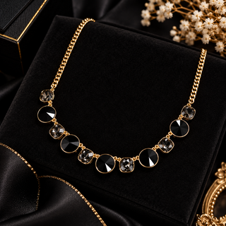 Gold-tone curb chain necklace with alternating black and gray faceted crystal bezel stones