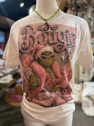 Cream graphic tee featuring bougie Grinch in pink fur with rhinestone text