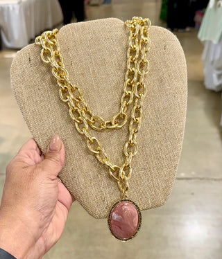Gold chunky double-strand chain necklace with large pink oval cabochon pendant