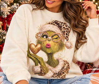 Cream crewneck sweatshirt with glamorous Grinch graphic in leopard Santa hat and rhinestone glasses