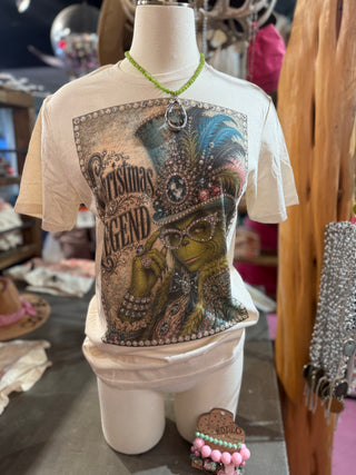 Cream graphic tee with ornate rhinestone-framed Grinch Christmas Legend print on mannequin