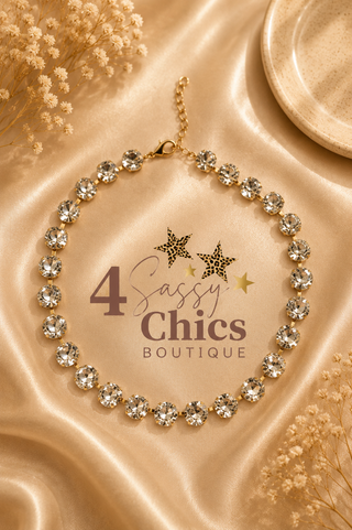 Gold-tone choker necklace with prong-set clear crystal rhinestones on satin fabric