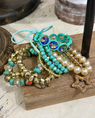 Turquoise and gold beaded bracelet stack with rhinestones, faux pearls, and pavé star charm