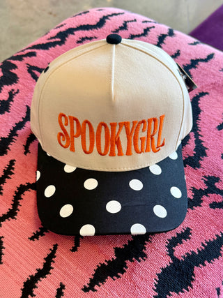 Cream snapback hat with orange SpookyGrl embroidery and black polka dot brim