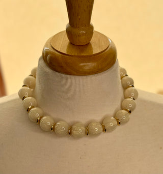 Cream chunky beaded choker necklace with gold disc spacers on mannequin