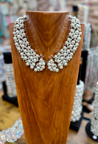 White faux pearl cluster collar necklace on wooden jewelry bust display