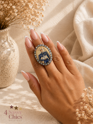 Oval cameo cocktail ring with iridescent rhinestones featuring illustrated cowboy figure on gold bezel
