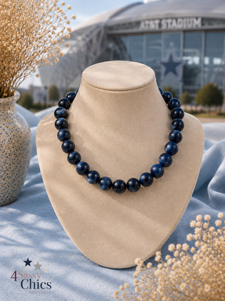 Navy blue large round beaded necklace on display bust, AT&T Stadium background