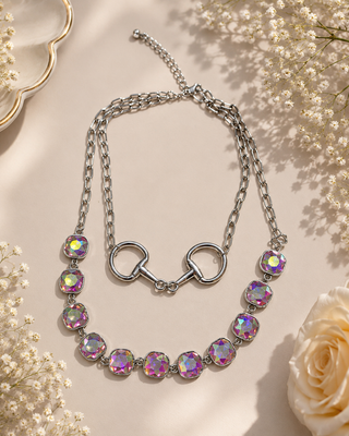 Layered silver necklace with iridescent faceted stones and snaffle bit centerpiece