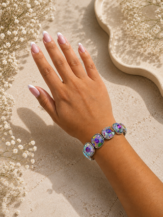 Iridescent cushion-cut crystal stretch bracelet with silver bezels on a wrist