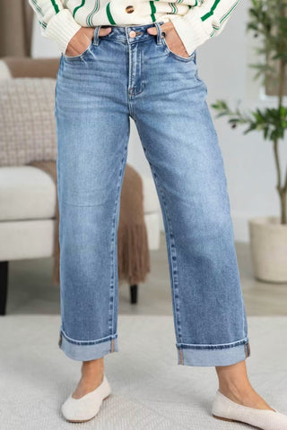 Light wash wide-leg high-rise jeans with deep folded cuff hem detail