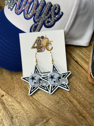 Dallas Cowboys star-shaped dangle earrings with football helmet design on display card