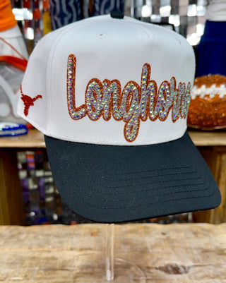 White and black trucker hat with rhinestone and burnt orange Longhorns script embellishment