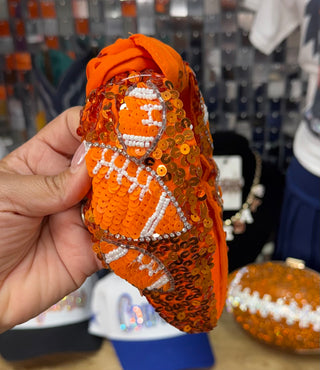 Orange sequin knotted headband with beaded football appliqué and rhinestone trim detail