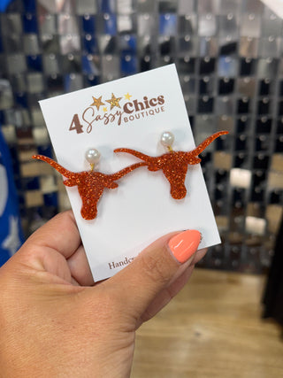Orange glitter longhorn steer head drop earrings with pearl studs on display card