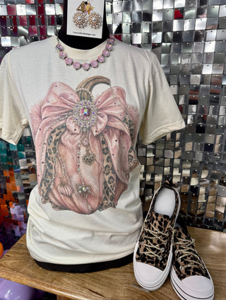 Cream graphic tee with rhinestone-embellished pumpkin, satin bow, and leopard-print design