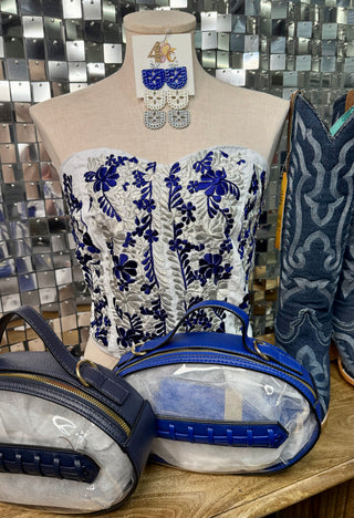 White strapless corset top with royal blue floral embroidery on mannequin
