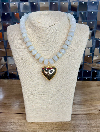White beaded necklace with gold spacers and large polished gold puffy heart pendant