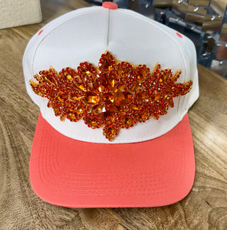 White coral snapback cap with large orange rhinestone crystal appliqué on front panel