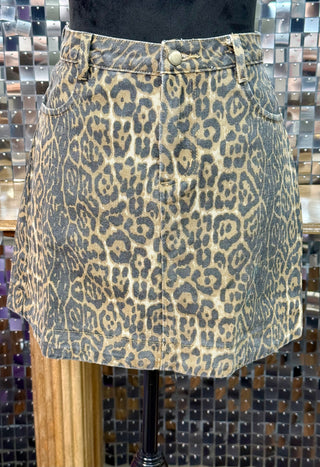 Leopard print denim mini skirt with snap closure, belt loops, and patch pockets