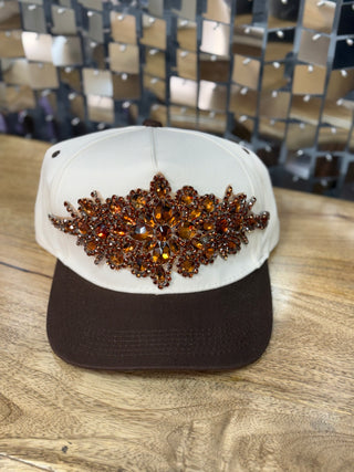 White and brown baseball cap with amber rhinestone floral starburst appliqué on front panel