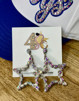 Silver iridescent rhinestone open star drop earrings on jewelry card
