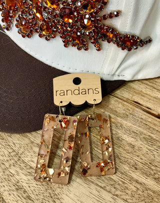 Caramel resin rectangle dangle earrings with gold foil flakes on wooden display card