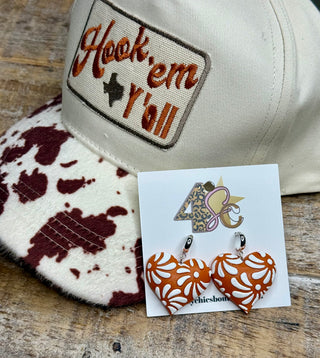 Orange and white heart-shaped Talavera floral dangle earrings on display card