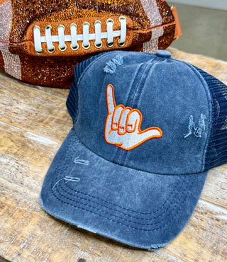 Distressed navy trucker cap with orange embroidered We're Number One hand gesture