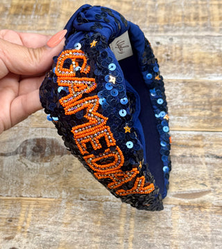 Navy sequin knotted headband with orange beaded Game Day lettering and gold star accents