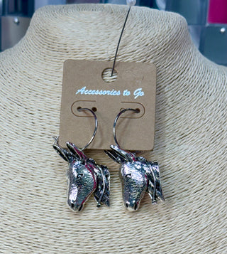 Silver metal donkey head dangle earrings on wire hooks, displayed on jewelry card