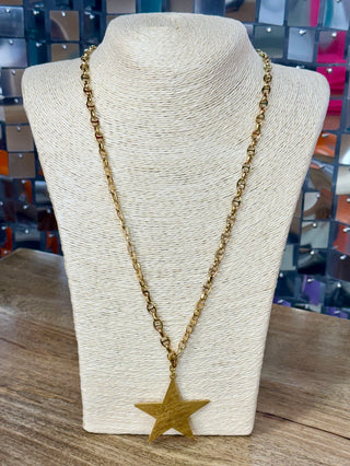 Gold anchor-link chain necklace with large brushed flat star pendant on display bust