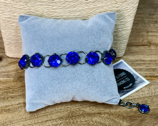 Blue crystal rhinestone tennis bracelet with dark gunmetal settings and extender chain