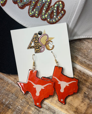 Burnt orange Texas-shaped dangle earrings with longhorn skull silhouette on gold fish hook wires