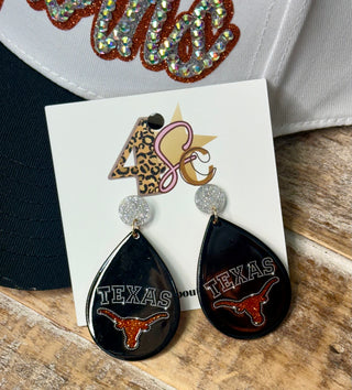 Black teardrop dangle earrings with Texas Longhorns glitter rhinestone design on card