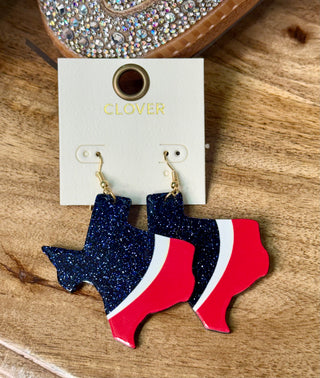 Texas-shaped dangle earrings in navy glitter and red white stripe on display card