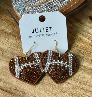 Brown rhinestone heart dangle earrings with silver crystal football lace detail on card