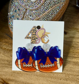 Acrylic football dangle earrings with blue bow and silver glitter stud tops