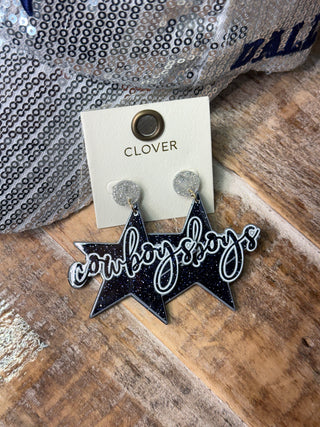 Black glitter star-shaped Cowboys dangle earrings with silver glitter studs on card