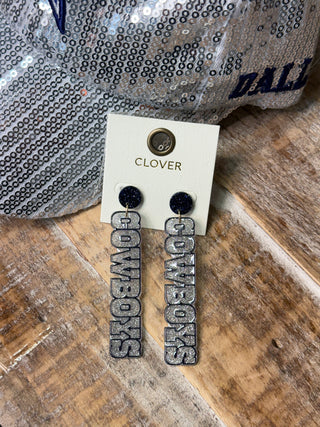 Silver glitter Cowboys dangle earrings with navy blue glitter round studs on display card