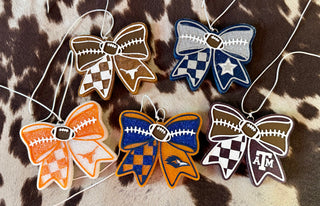 Five football bow-shaped car fresheners in college team colors including Texas Longhorns and Texas A&M