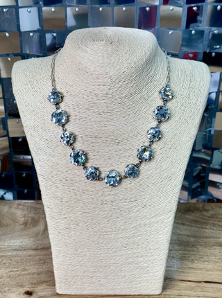 Silver-toned collar necklace with large faceted clear crystal stones in pronged settings