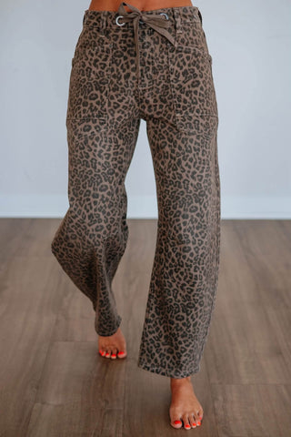 Wide-leg brown leopard print pants with lace-up grommet waist and patch pockets