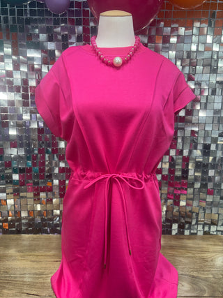 Fuchsia short-sleeve drawstring waist knee-length dress on mannequin with pink beaded necklace